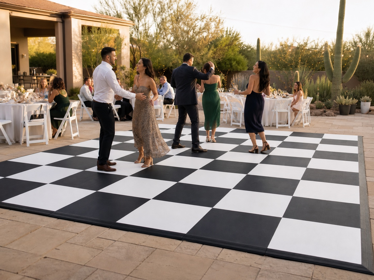 Guests dancing on a black-and-white checkered dance floor at an Arizona outdoor event